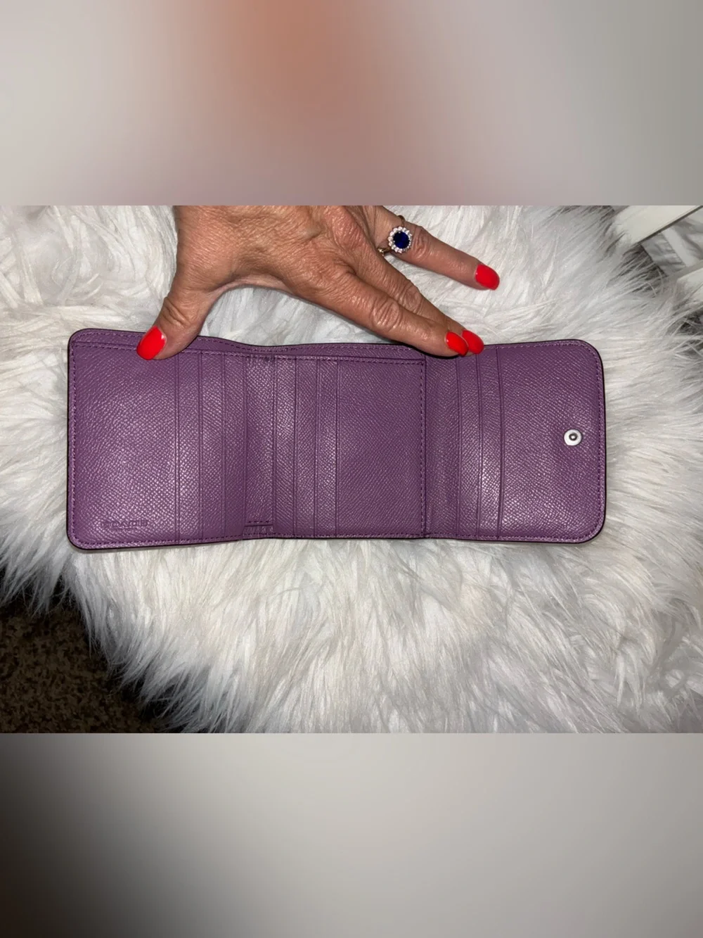 Coach Compact Trifold Pebbled Leather Wallet button closure in Plum/Purple.
